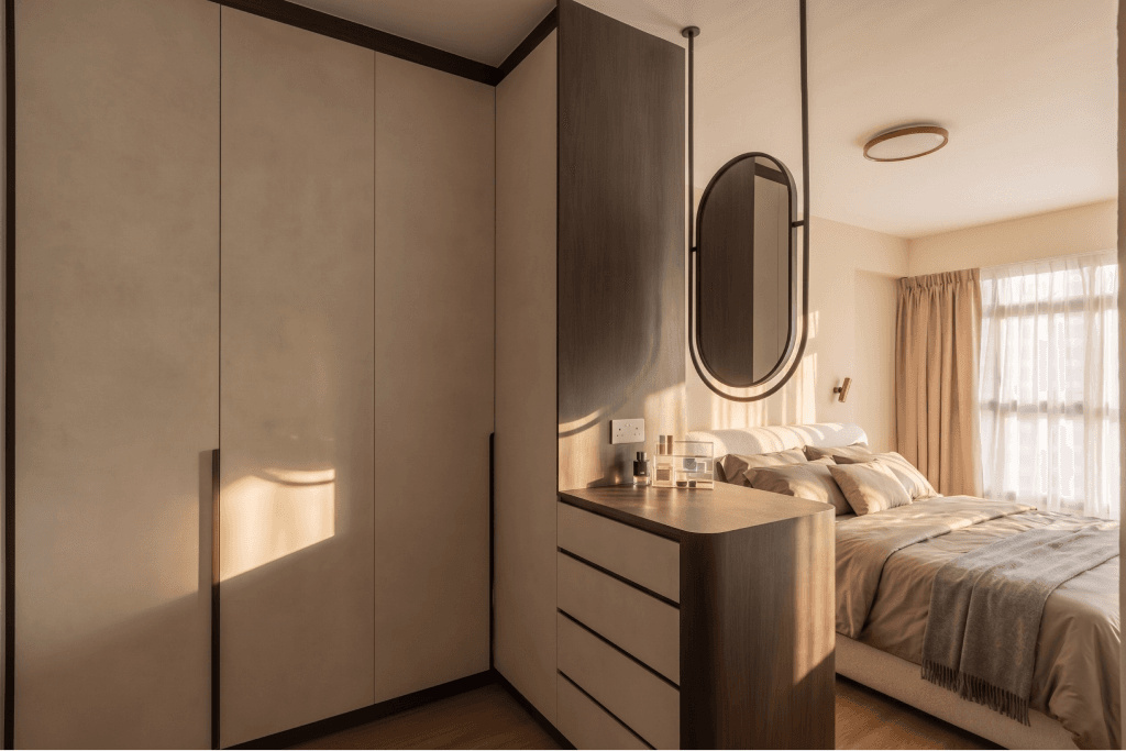 A newly renovated BTO bedroom with built-in wardrobes, a dresser and an oval mirror